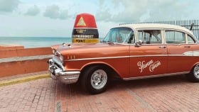 The Havana Cabana\s 1957 Chevrolet Bel Air 4-door Sedan parked by the Southernmost Point attraction in Key West.