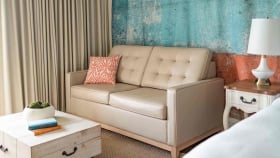 A close-up on the leather couch overlooking the wooden coffee table