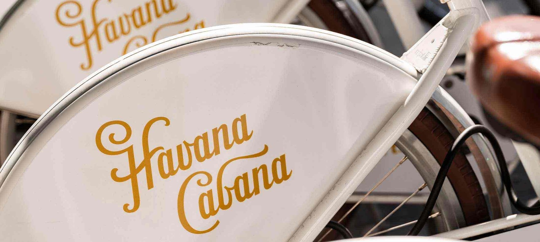 A close focus on the Havana Cabana logo placed on the top corder of the bikes' tires