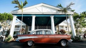 A classic car parked in front of the Havana Cabana building