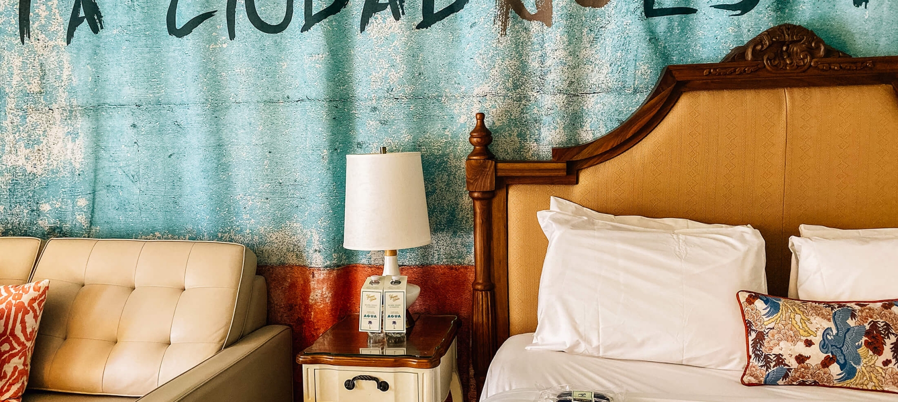 A close focus on the lamp placed on a shared bedside table in between the queen bed and couch