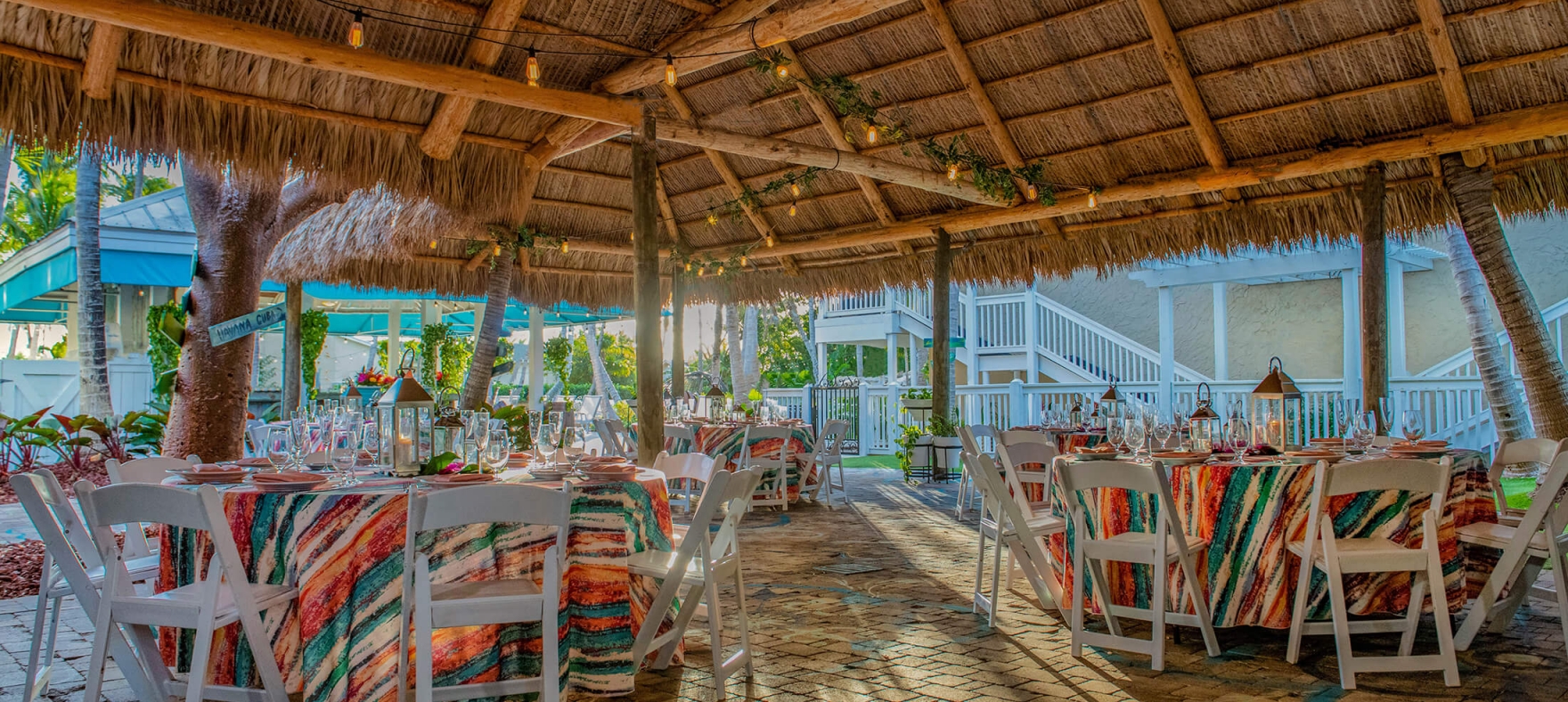 Tiki Hut dining layout and decor with string lights on the straw rooftop