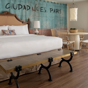 An interior view of Havana Cabana's mobility accessible rooms, equipped with a King bed and dining table.