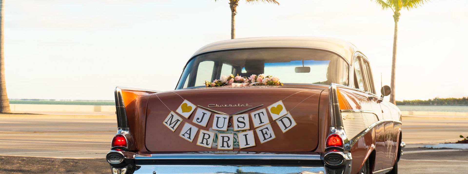 A 1957 Chevrolet Bel Air 4-door Sedan with the sign 'Just Married' on the trunk.