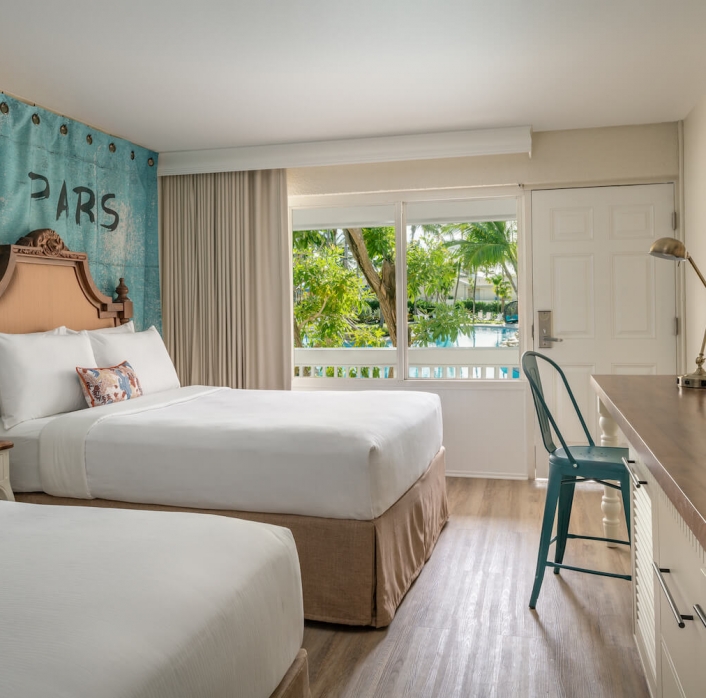 View of two queen beds in a Havana Cabana hotel room.