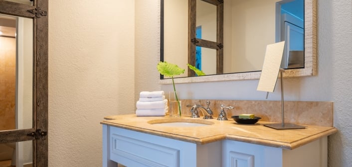 View of a white and sand colored bathroom vanity