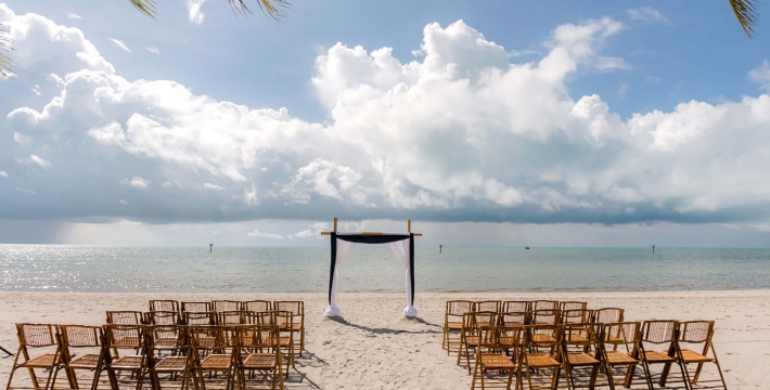 Outdoor beach wedding decor with guest sitting area followed by the aisle