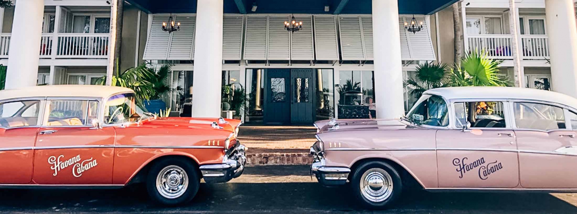 Two 1957 Chevrolet Bel Air 4-door Sedans parked on the street.