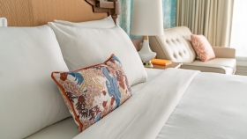 A close up view of pillows on a king bed.