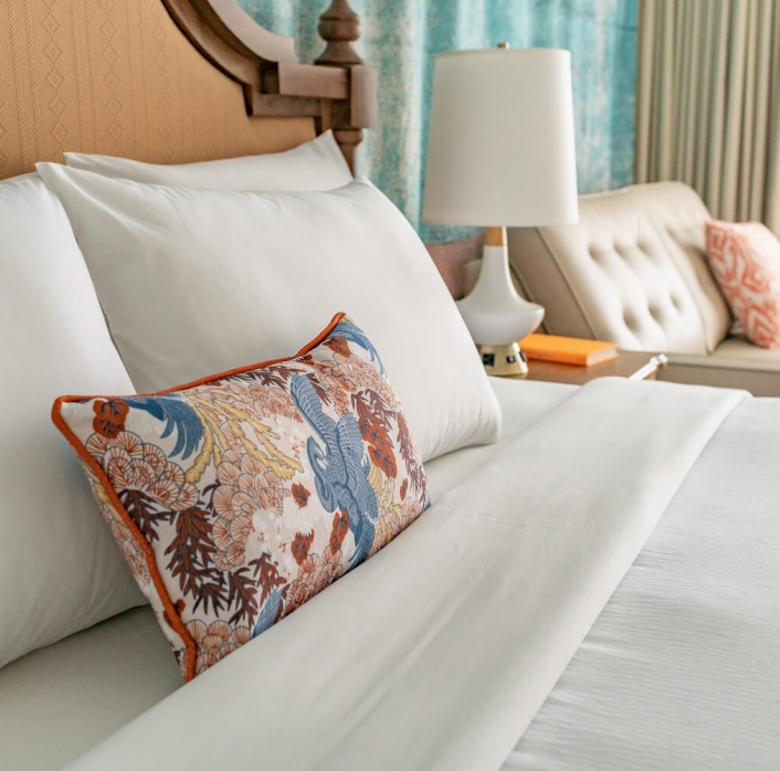 A close up view of pillows on a king bed.