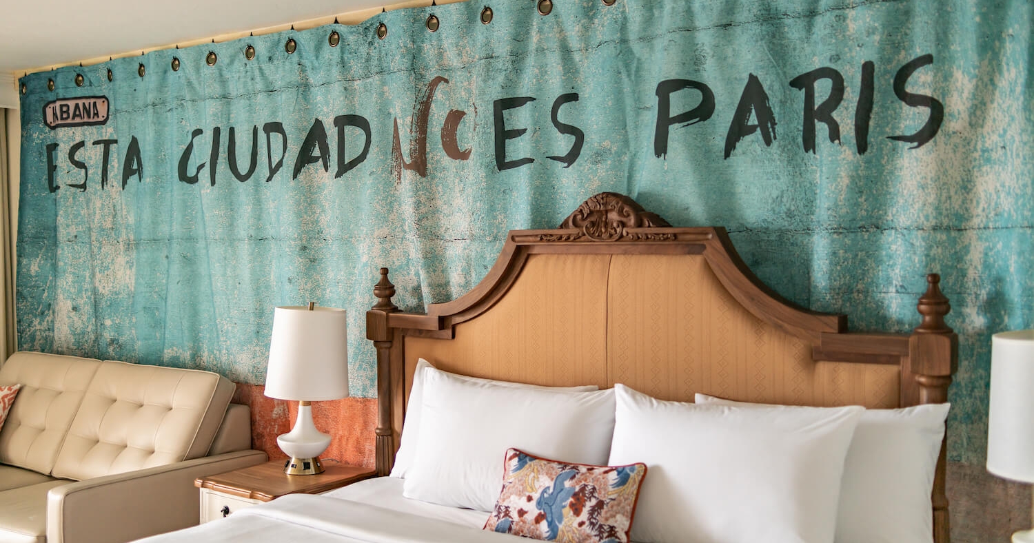 A view of an intricate headboard on a king bed at Havana Cabana.