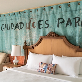 A view of an intricate headboard on a king bed at Havana Cabana.