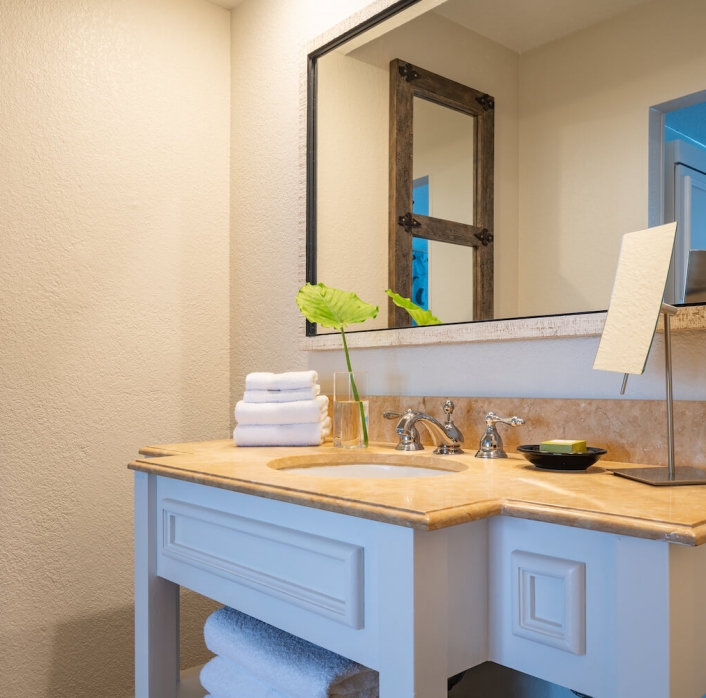 A view of the bathroom mirror and sink in the mobility accessible studio at Havana Cabana resort.