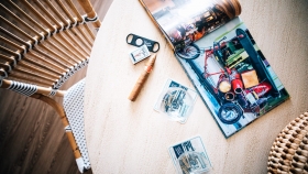 A top down view of a table with a magazine and cuban cigars.