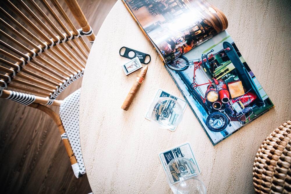 A top down view of a table with a magazine and cuban cigars.