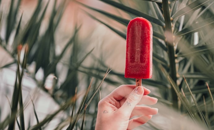 A close up of a red popsicle.