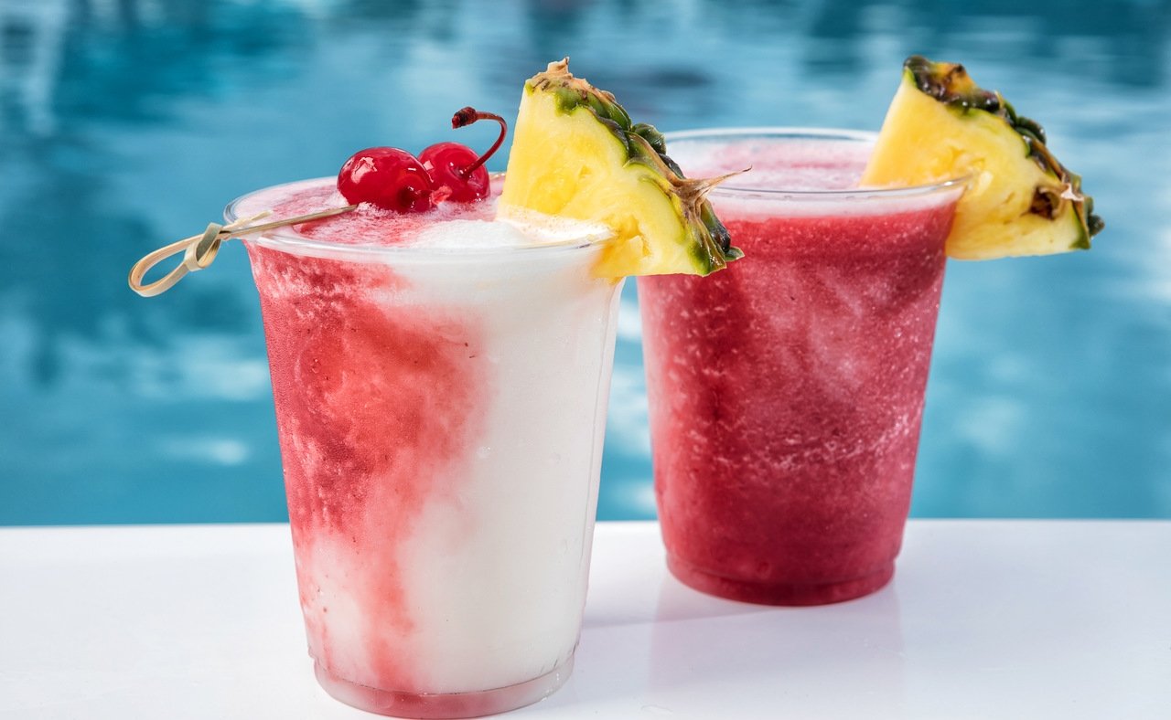 photo of two frozen cocktails by the pool