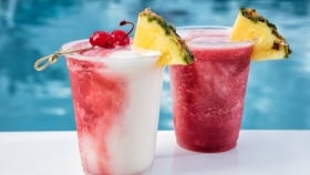 photo of two frozen cocktails by the pool