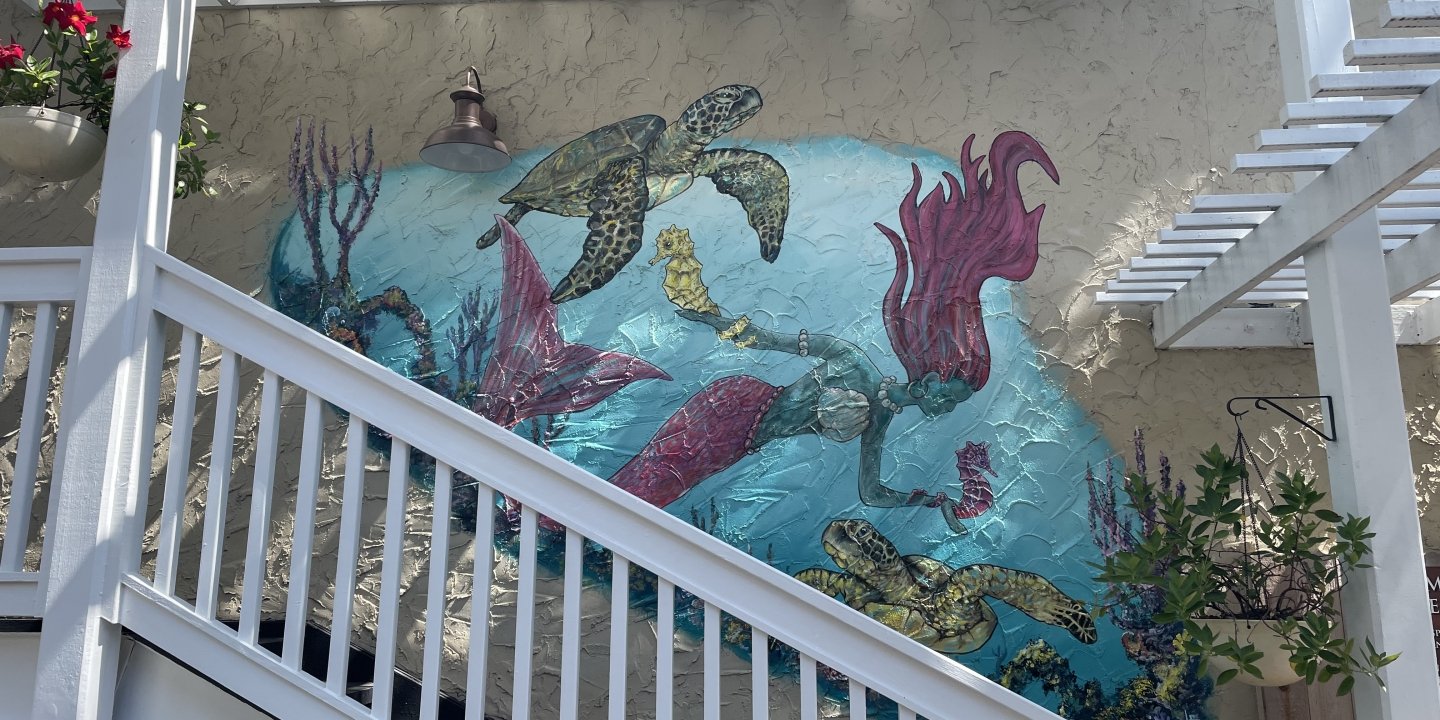 a painting of a mermaid on the wall