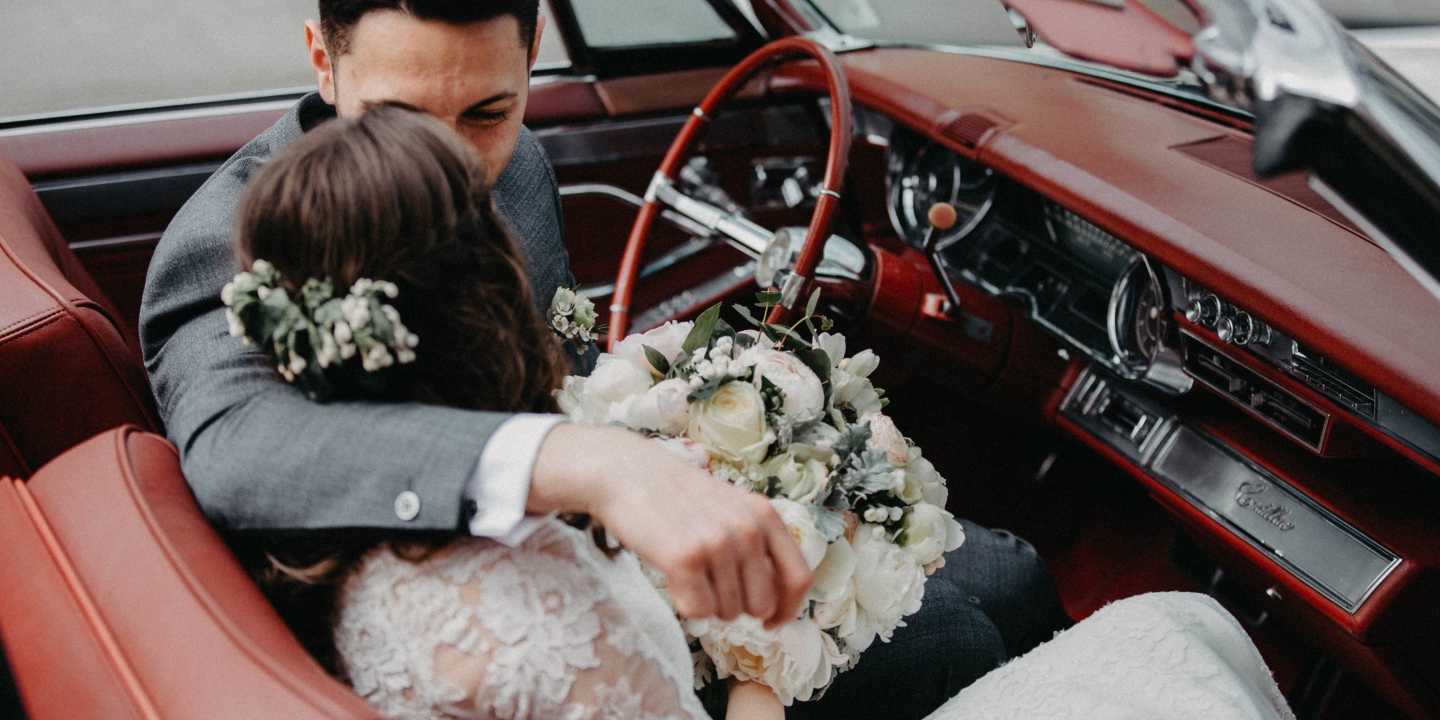 a wedding couple in a classic car