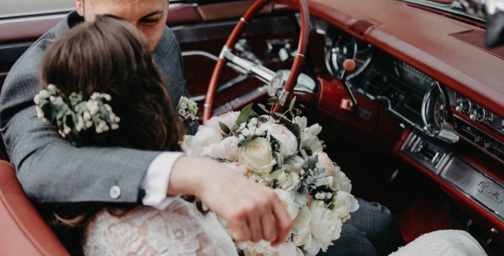 a wedding couple in a classic car